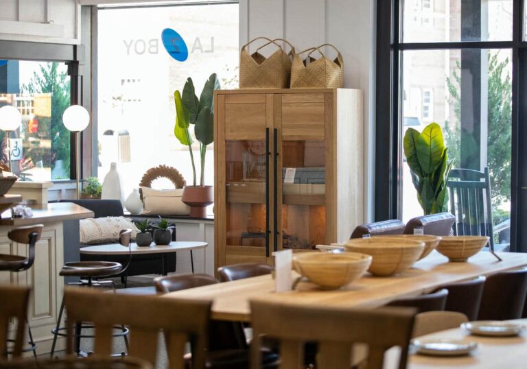 Modern home decor store interior with furniture and plants.